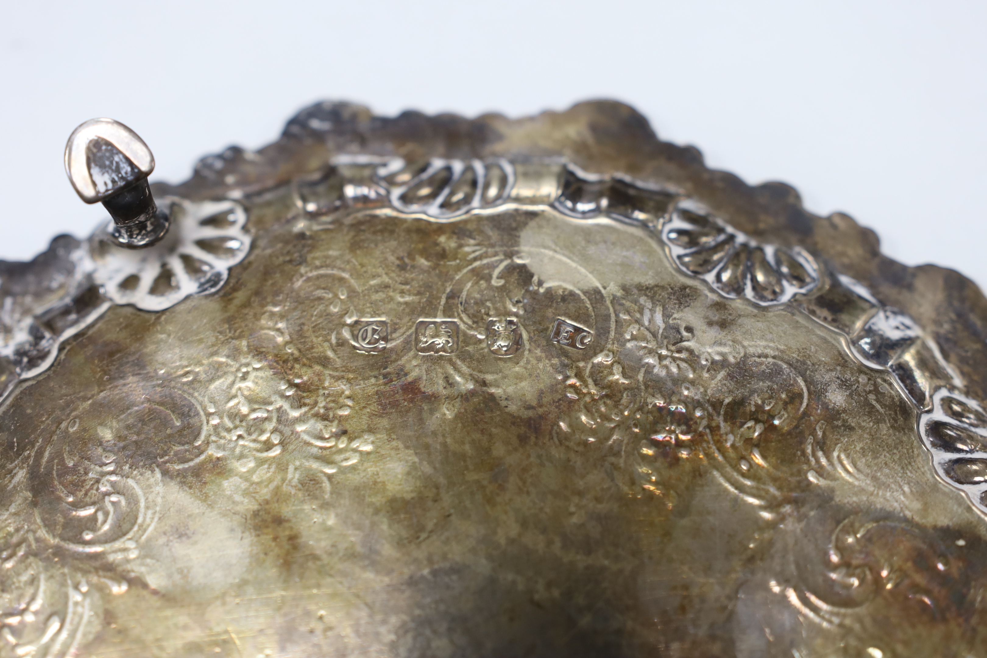 A late George II silver waiter, with engraved crest and later chased decoration, Ebenezer Coker, London, 1758, 19.2cm, 8.4 oz.